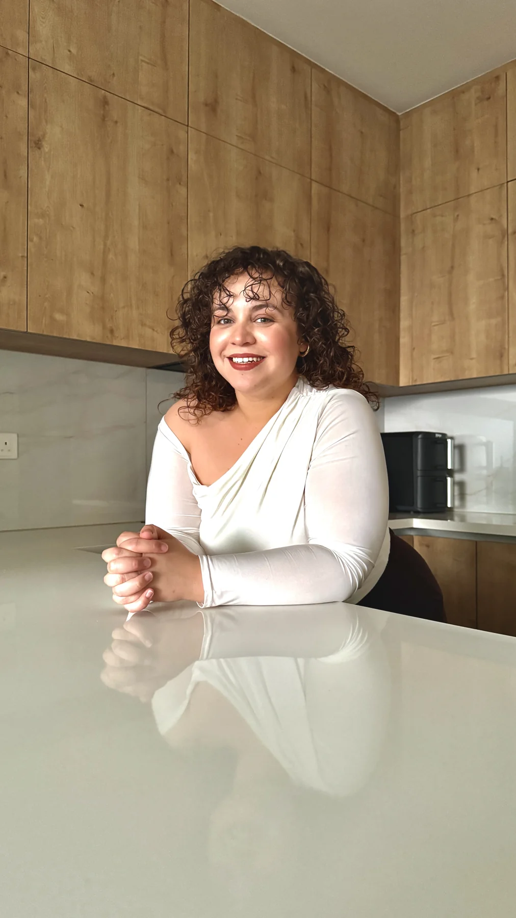 Eleni seated at a kitchen counter